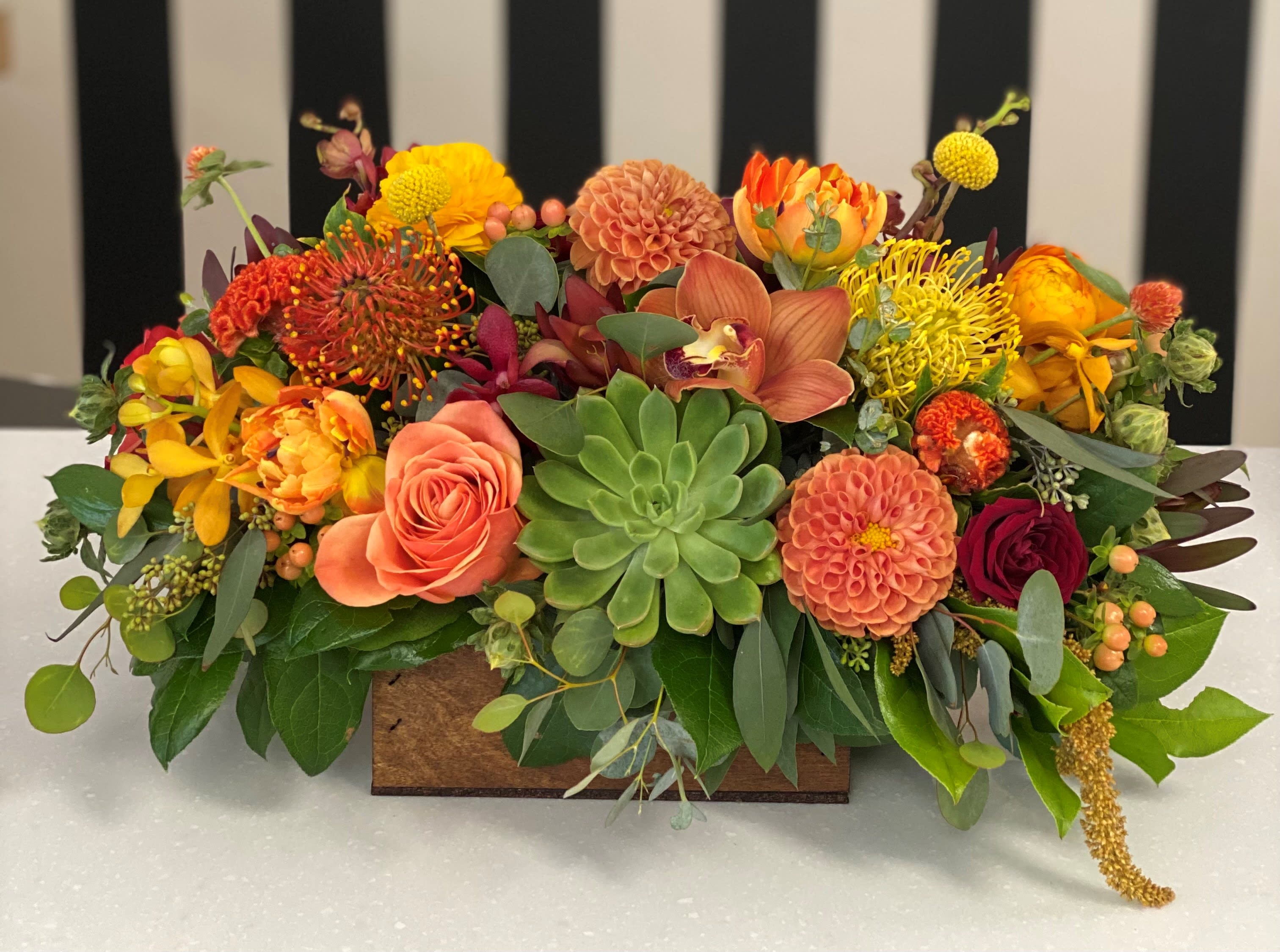 Fall Long Box - Fall colored flowers, roses, and orchids in a wood box. Specific flowers used based on availability 