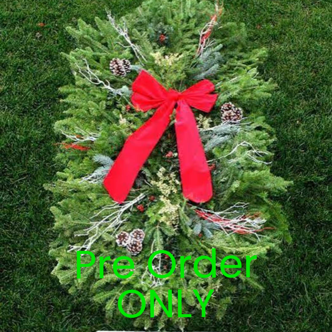 Holiday wreath with a red bow and pinecones on a green background
