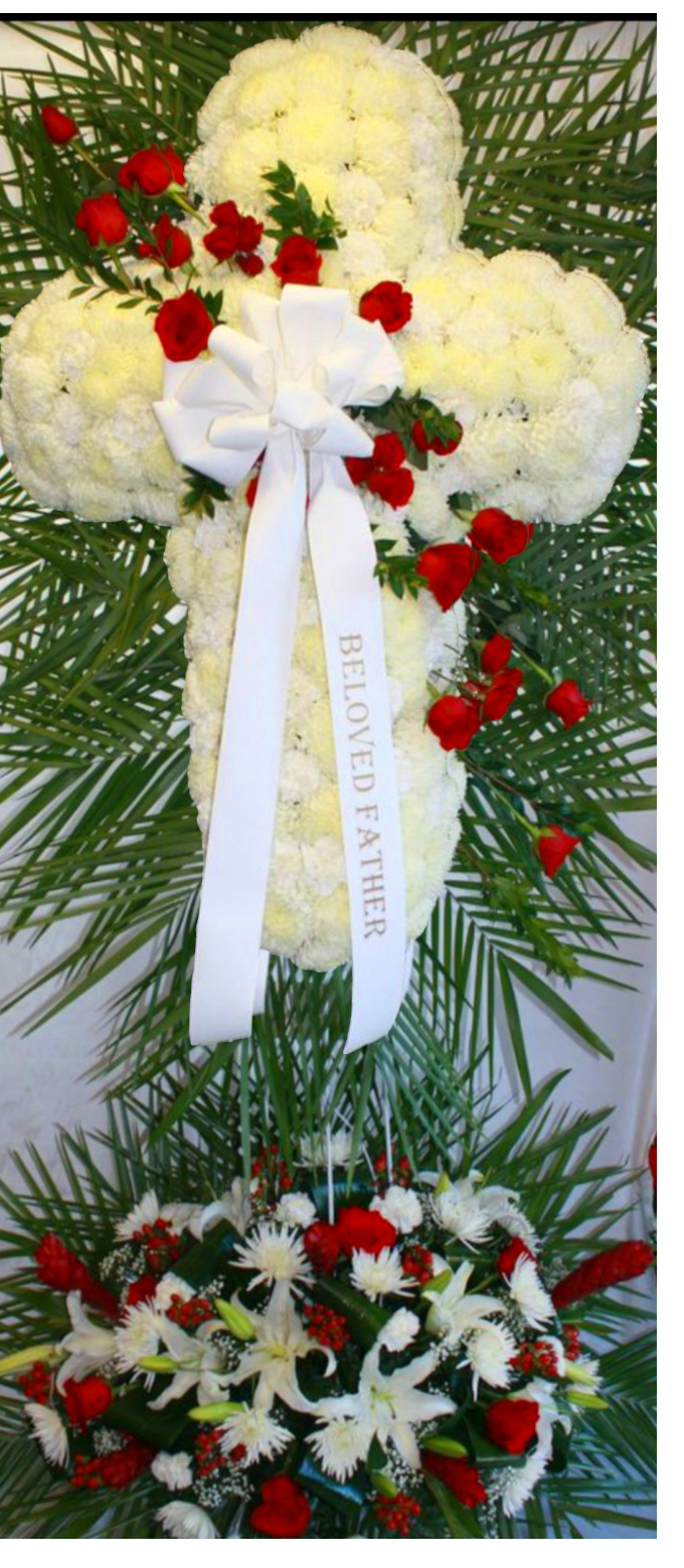 BLEEDING CROSS WITH BOTTOM CENTERPIECE - This is a two piece centerpiece with a white cross made out of chrysanthemums with a red rose break, to create a bleeding cross with a secondary centerpiece at the bottom with exotic flowers, red ginger lilies, white casablanca lilies, red and white roses. Also included is a bow and 2 doves flying towards heaven.