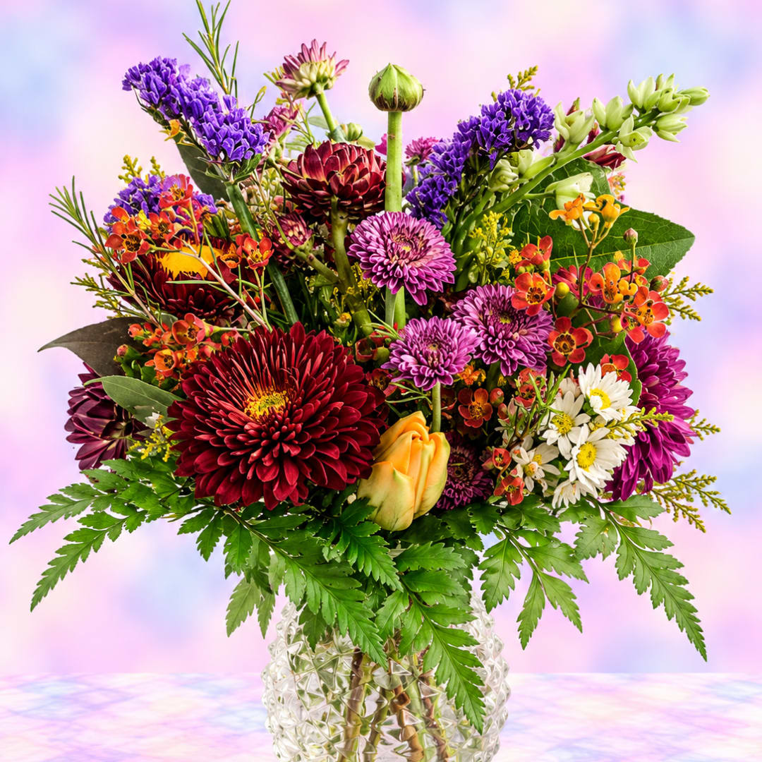 Colorful mixed bouquet in a clear textured vase