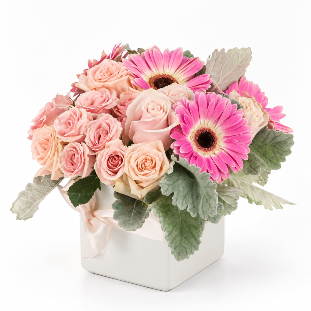 Pink roses and gerbera daisies in a white square vase
