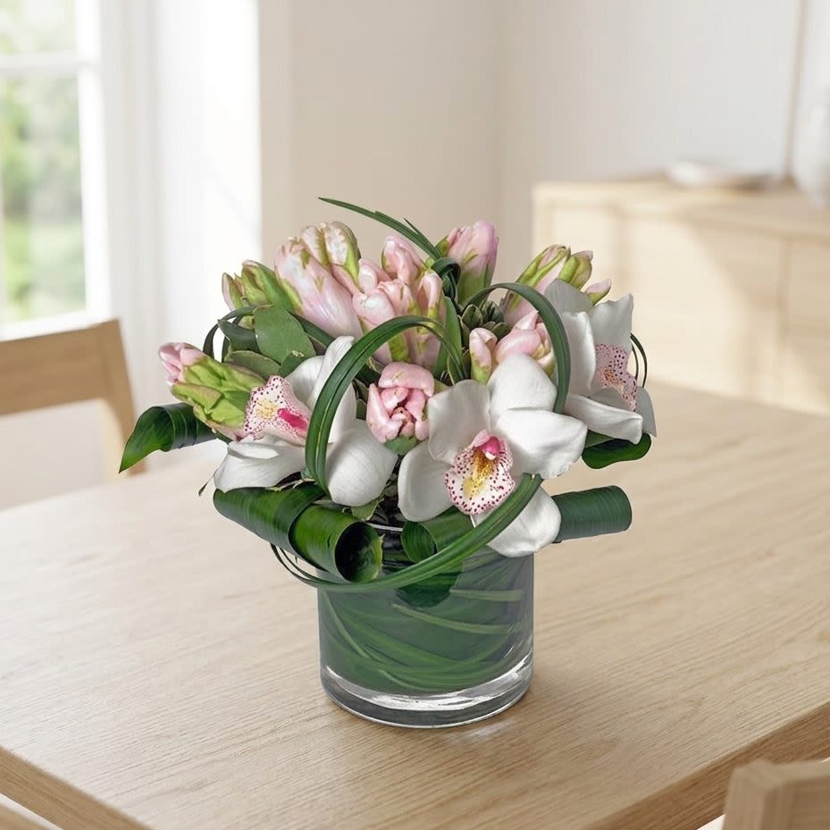 Pink and white orchid bouquet in a glass vase