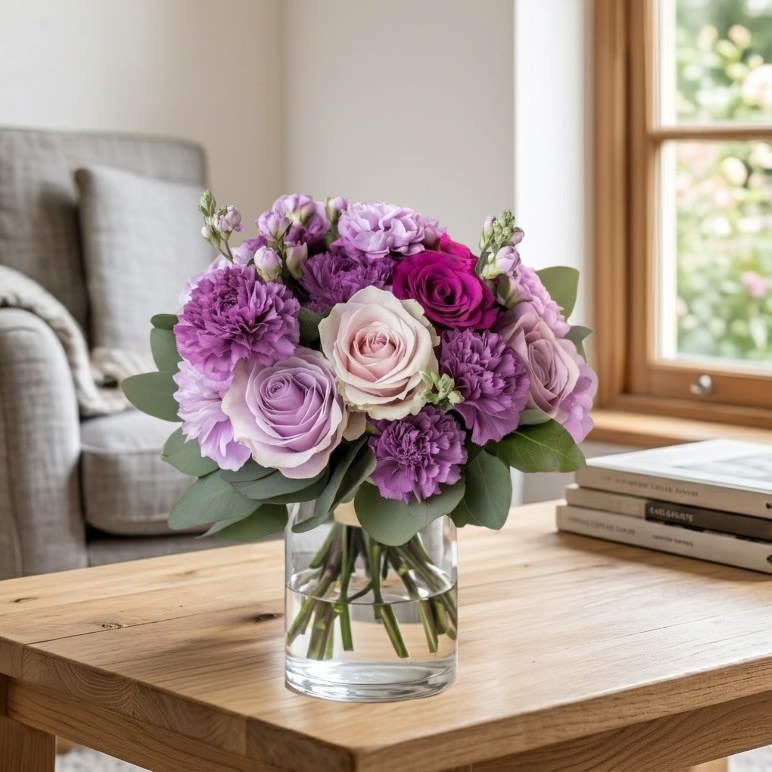 Lavender Bliss - Soft blush roses meet vibrant purple carnations in a charming bouquet that speaks of love, gratitude, and timeless elegance.