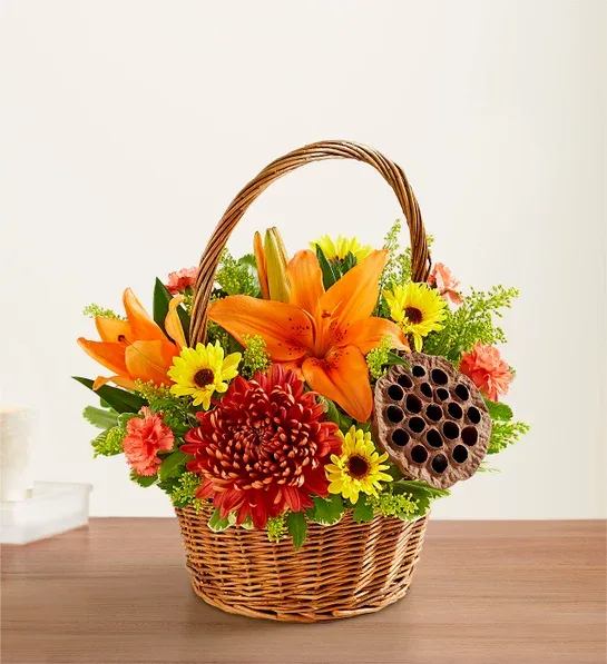 Fall gathering basket - Warm autumn colors arranged artfulling in a wicker basket. ( Basket design may vary)