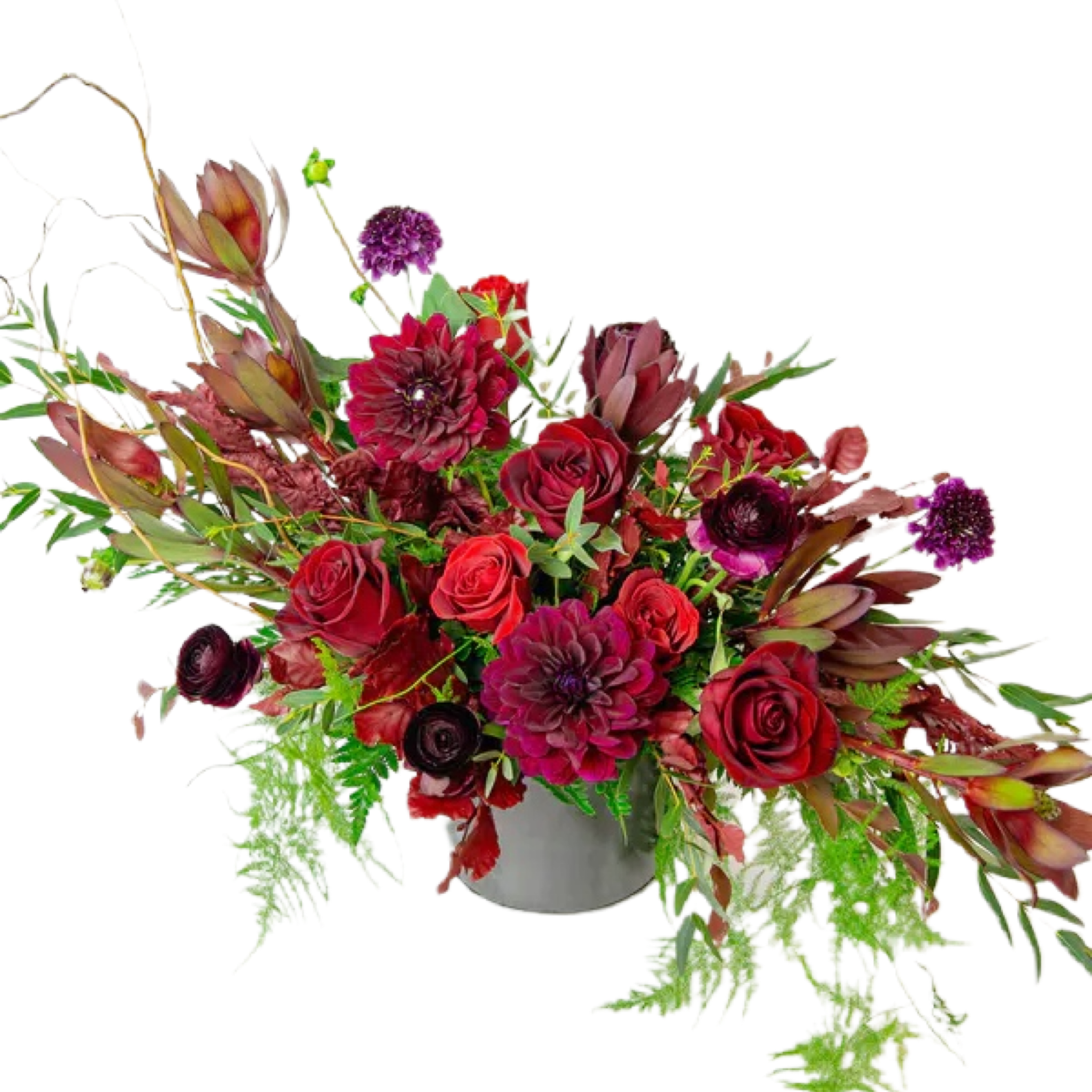 Red and burgundy floral arrangement in a gray vase