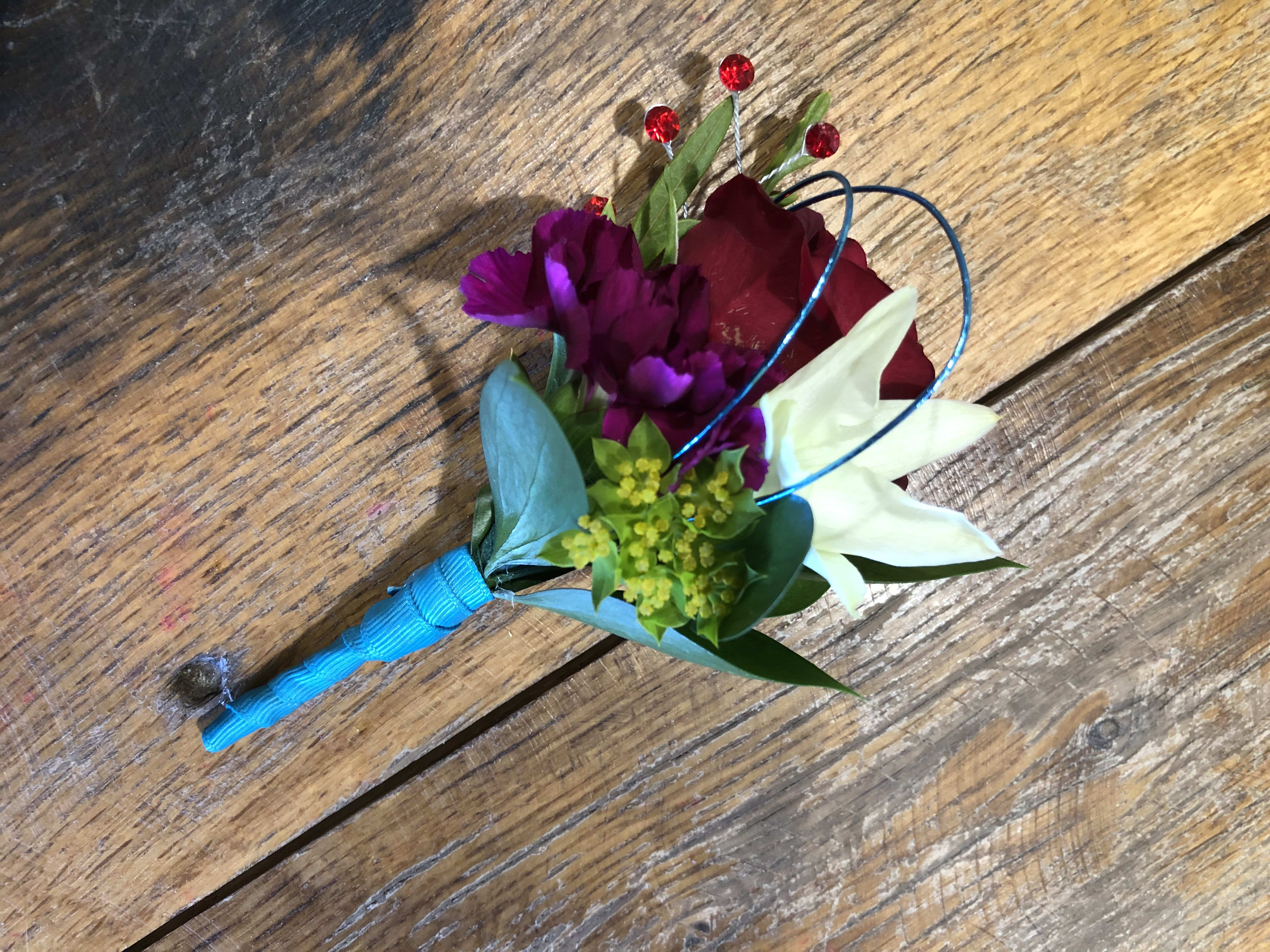 Small boutonniere with red, purple, and white flowers