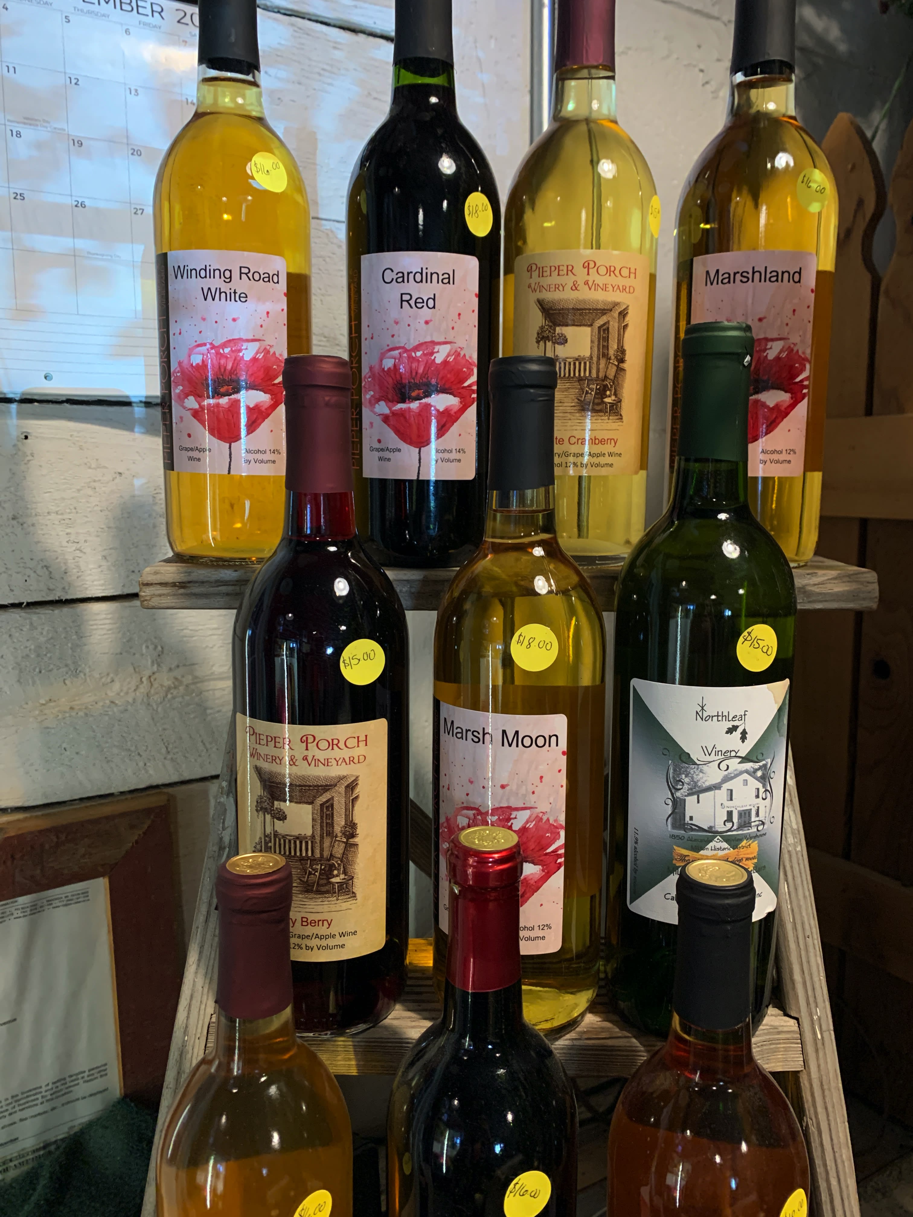 Assorted wine bottles displayed on wooden shelves