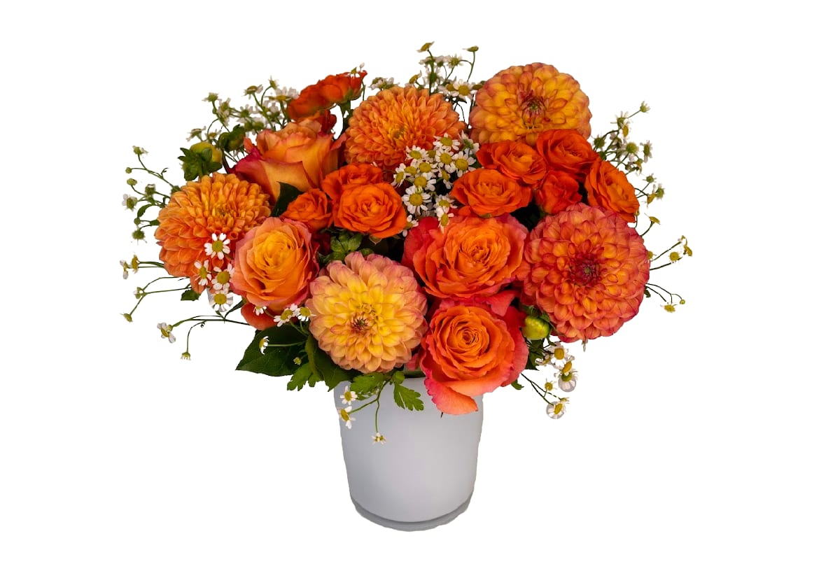 Orange and peach flower arrangement in a white vase