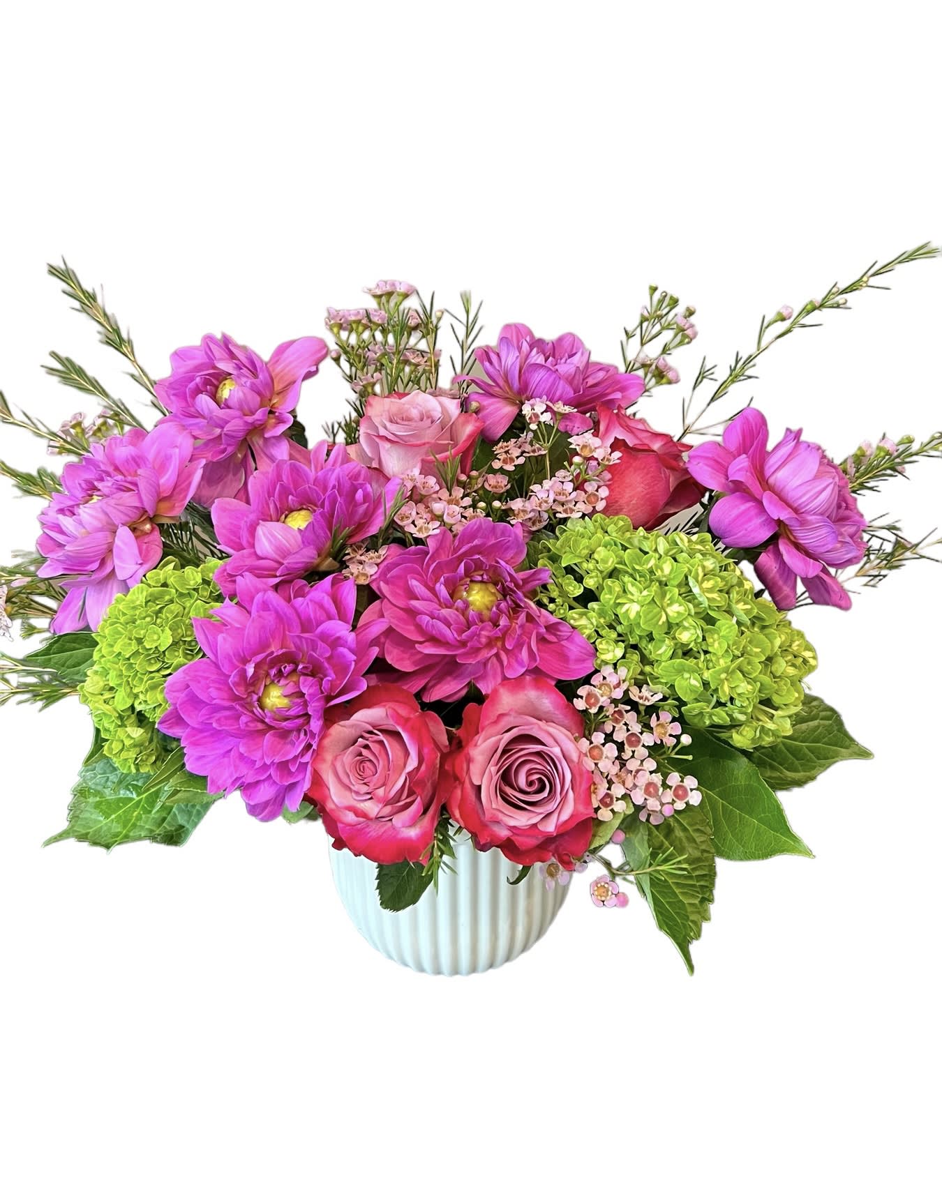 Pink and magenta flowers arranged in a ribbed white vase