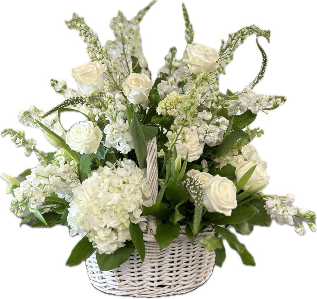 White roses and hydrangeas in a white wicker basket
