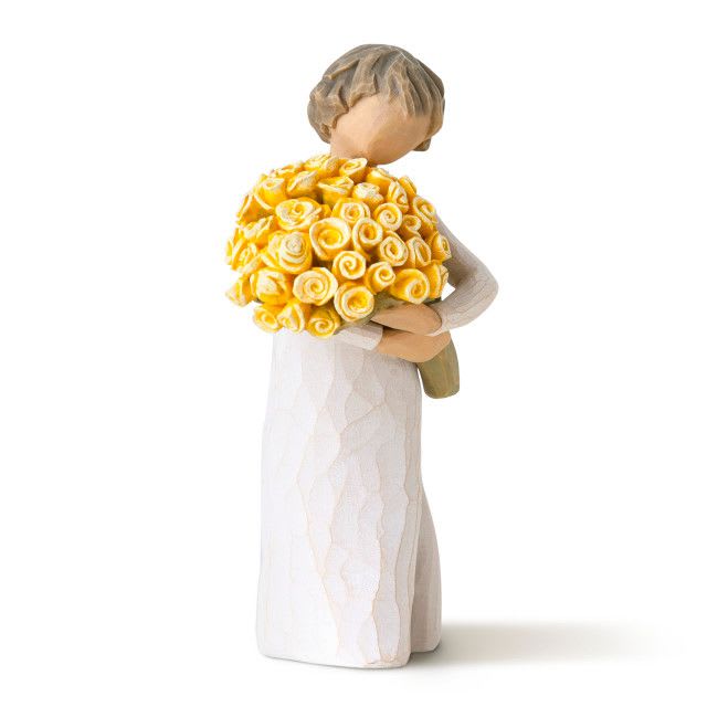 Figurine of a bride holding a bouquet of yellow roses