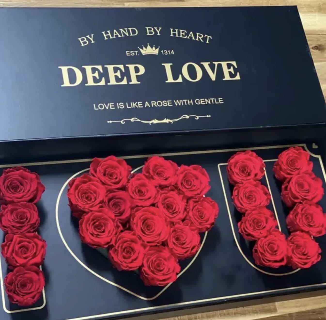 Red roses arranged in a heart-shaped box with matching rose letters
