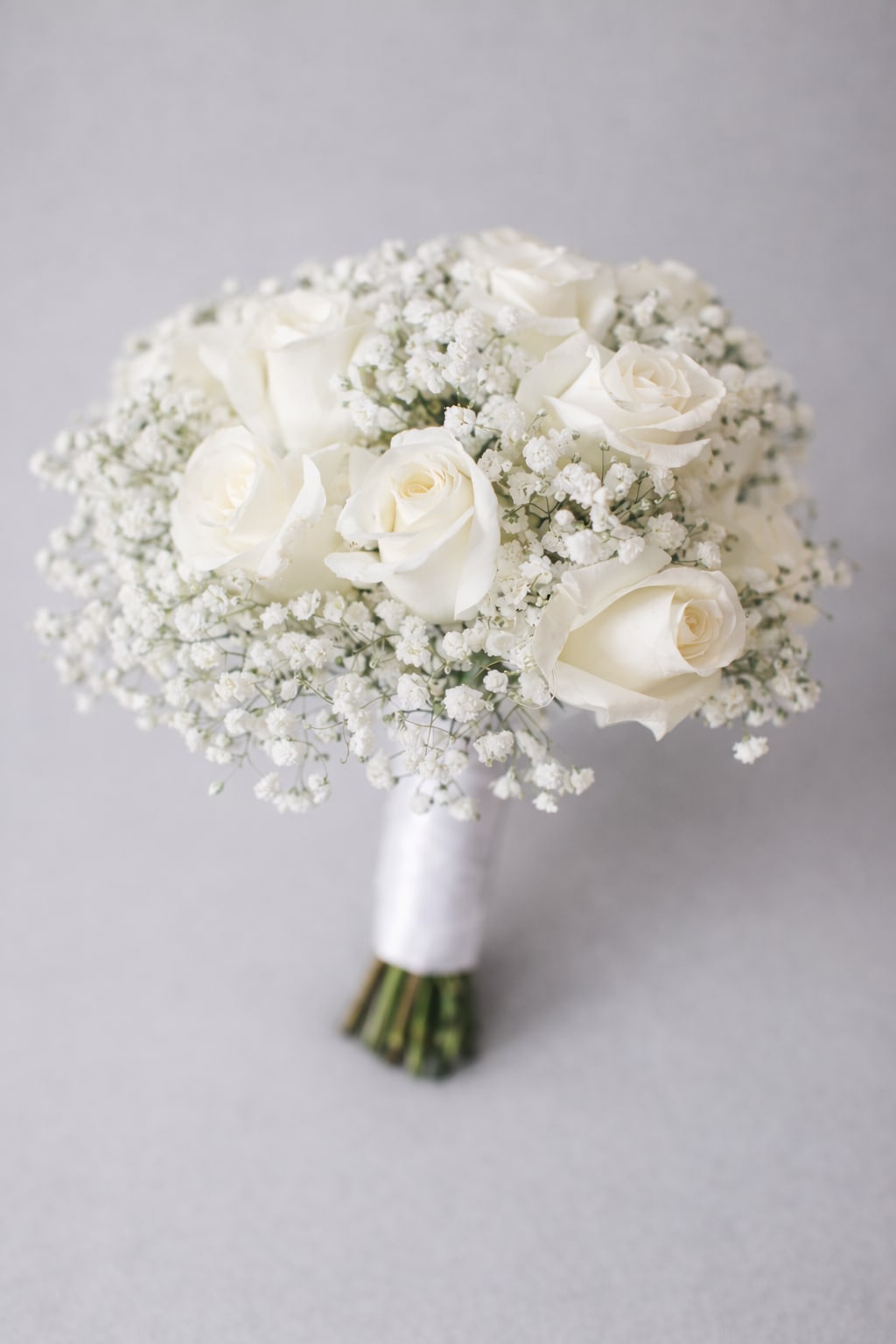 White rose bouquet with baby's breath and wrapped stems