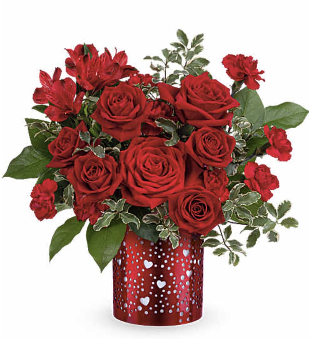 I heart You - Let your love shine with Teleflora's I Heart You Bouquet, featuring a passionate mix of red roses, alstroemeria, and carnations arranged in a red metal lantern adorned with charming heart and dot cutouts-a heartfelt Valentine's Day keepsake. Teleflora's I Heart You Bouquet includes red roses, red spray roses, red alstroemeria, red miniature carnations, lemon leaf, and pitta negra, beautifully arranged in Teleflora's I Heart You Lantern, a red metal lantern with heart and dot cutouts. Orientation: All-Around 