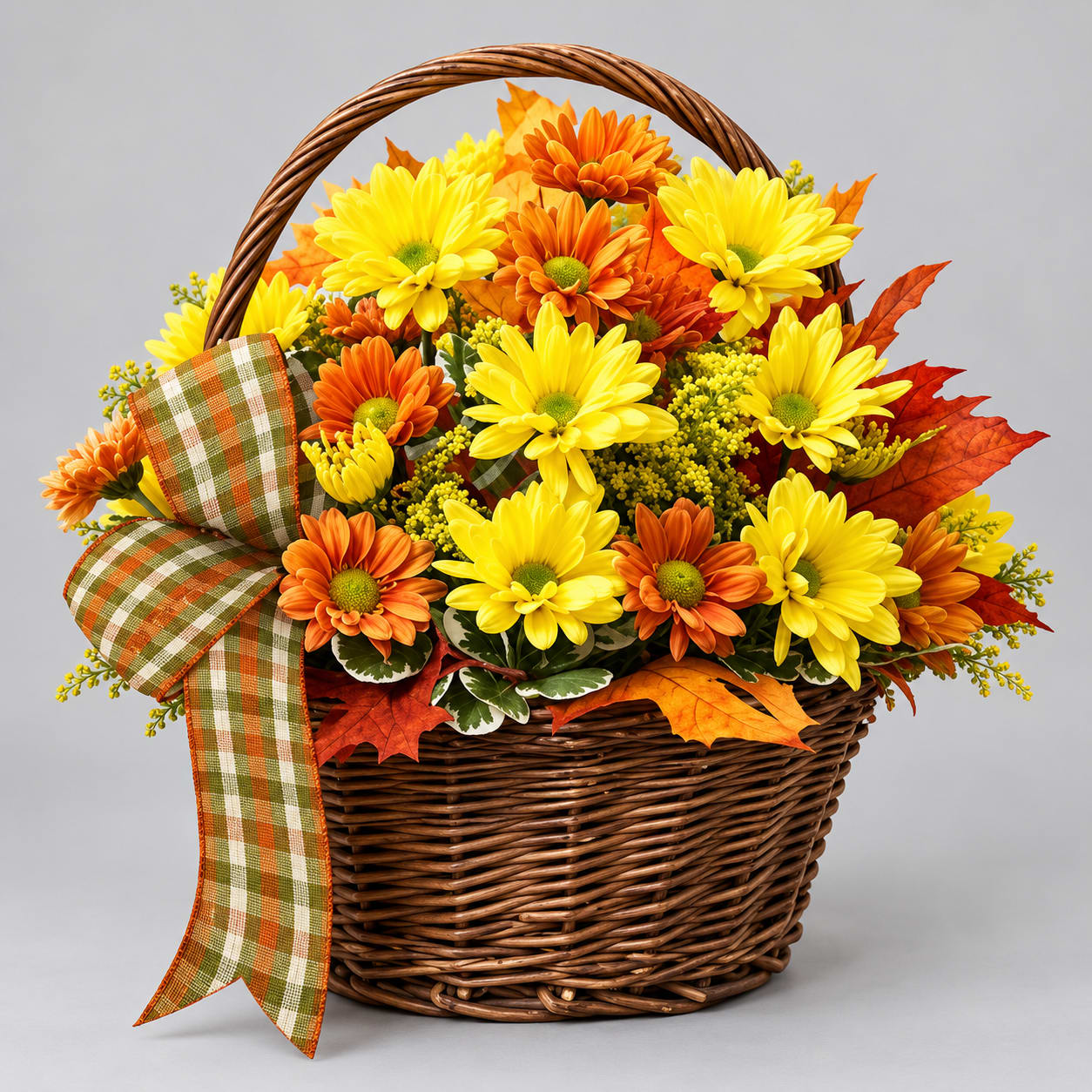 Yellow and orange daisies in a wicker basket with a plaid ribbon