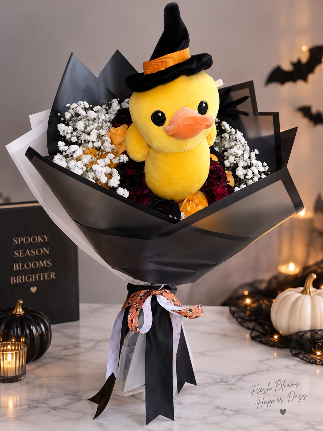 Bouquet with a plush yellow duck in a witch hat surrounded by flowers
