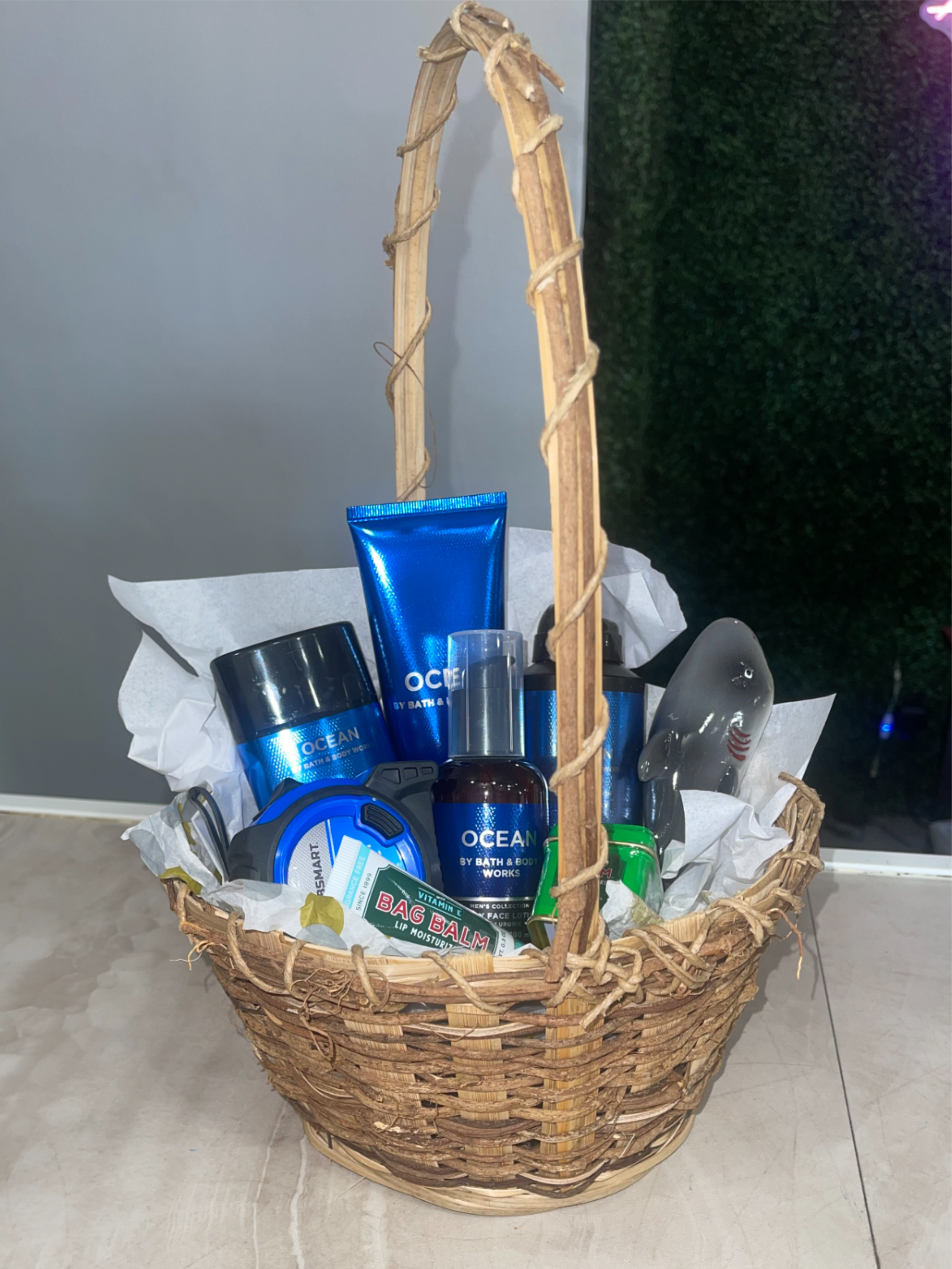 Dads Gift Basket - Give a man in your life a practical, polished surprise with this wrapped gift basket designed for Father's Day, birthdays, or any "just because" moment.  the kind of ready-to-gift presentation that makes the recipient feel appreciated the moment he sees it.  Inside, find an assortment of bath and body works men's handy grooming products arranged neatly in the basket. Everything is secured with plastic wrap and a decorative ribbon.  This set is ideal for the dad who prefers useful, everyday comforts over floral arrangements - a thoughtful way to say thanks, celebrate a birthday, or mark Father's Day. The basket ships ready to present; for any special notes or delivery instructions, include them at checkout so we can personalize the gift tag.