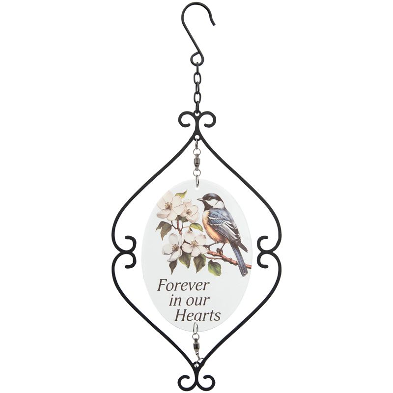 Hanging memorial plaque with bird and white blossoms inside a black metal scroll frame