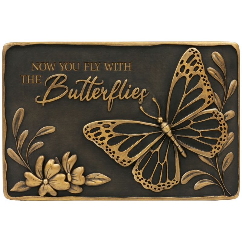 Bronze-colored memorial plaque with butterfly, flowers, and the words Now you fly with the butterflies.