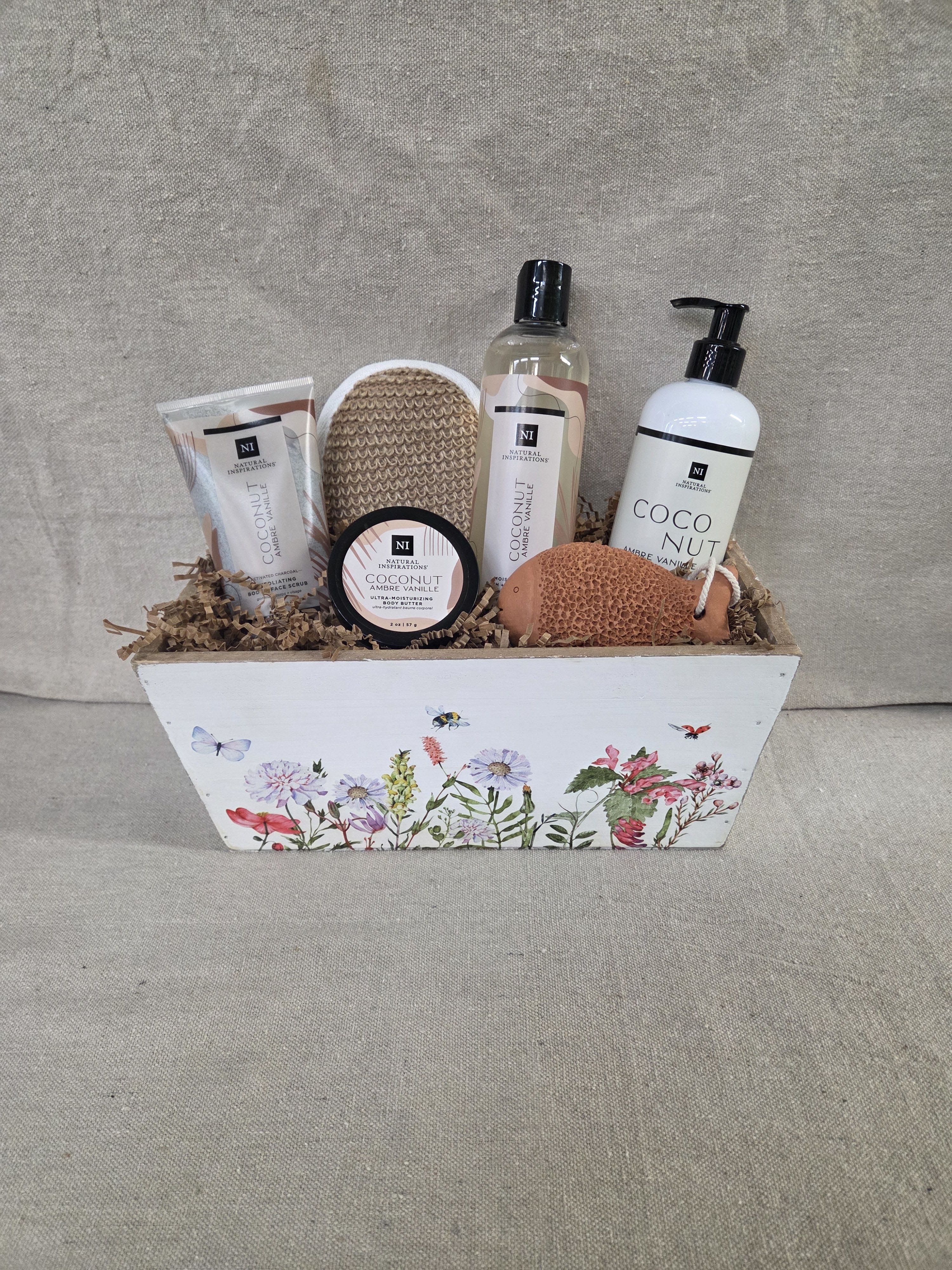 Spa Basket - Coconut - Coconut Amber Vanilla Spa Basket - Indulge in a seductive blend of creamy Coconut, warm Madagascar Vanilla, and soft Amber. Pure essential oils of Mandarin and Iris meld with the soft undertones of Sandalwood to create an exotic fragrance that is warm, sensual and enticing. Our spa baskets include a variety of bath and body products in soothing scents packaged in a decorative container.
