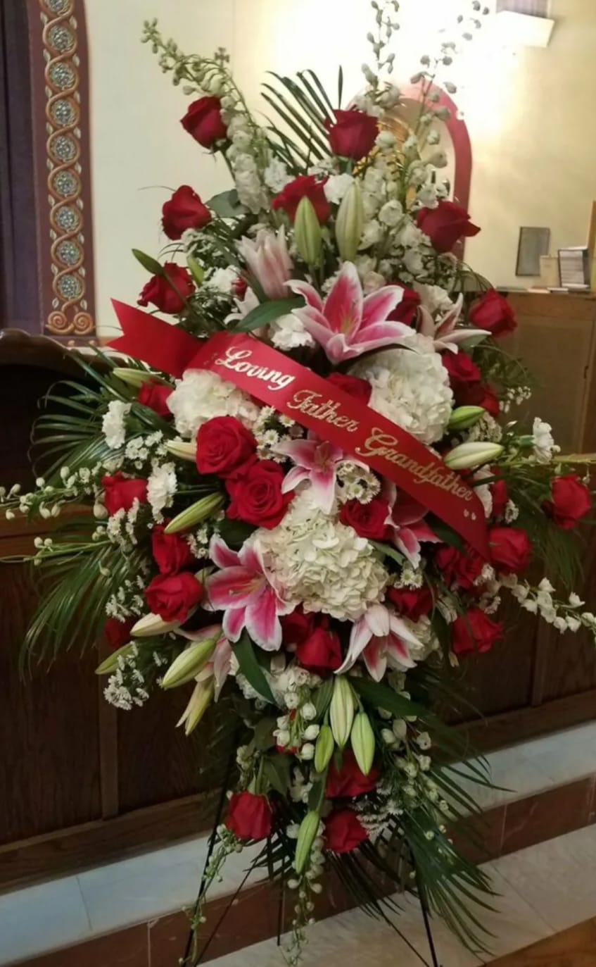 Large standing floral spray with red roses and pink lilies