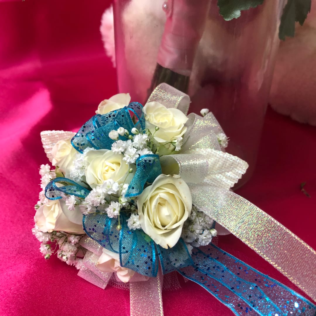 Small bouquet of white roses with blue and silver ribbon accents