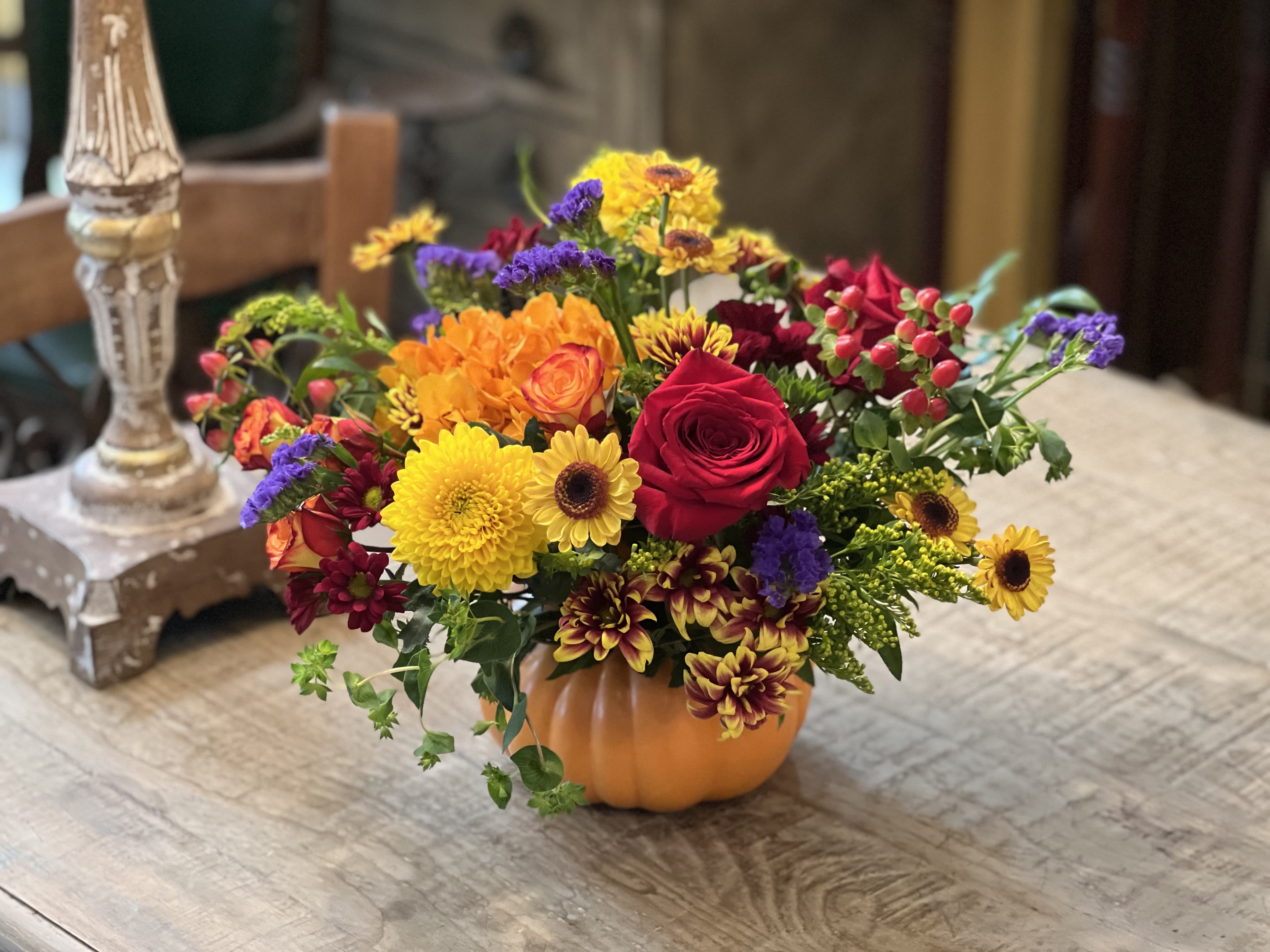 Colorful mixed bouquet in a small orange pumpkin container