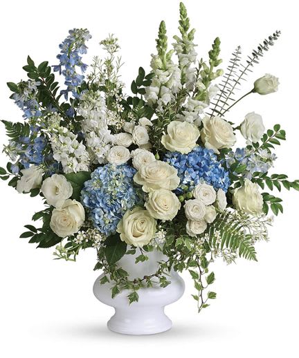 Blue and White Floor Spray - White and blue roses, hydrangeas and Stocks arranged with greenery in a white pedestal vase-serene, layered floor spray ideal for sympathy or elegant event settings.