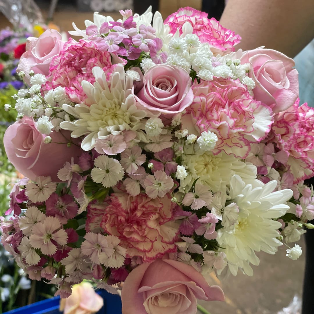 Pink and white bouquet with roses, carnations, and daisies
