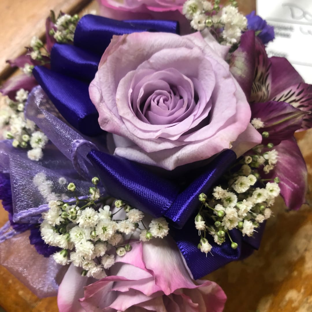Lavender rose bouquet with purple ribbon and small white filler flowers