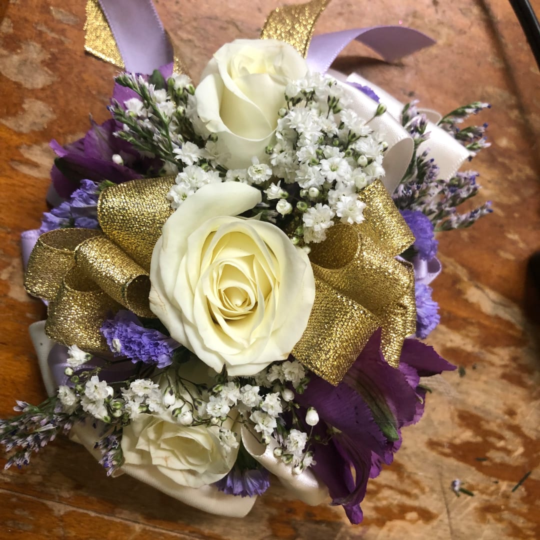 White roses with purple flowers and gold ribbon accents