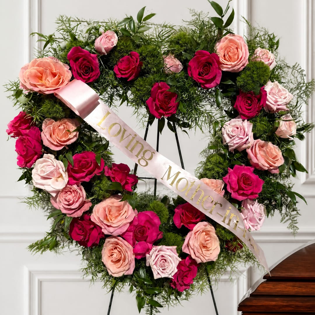 Heart-shaped rose wreath with a satin ribbon reading Loving Mother-in-
