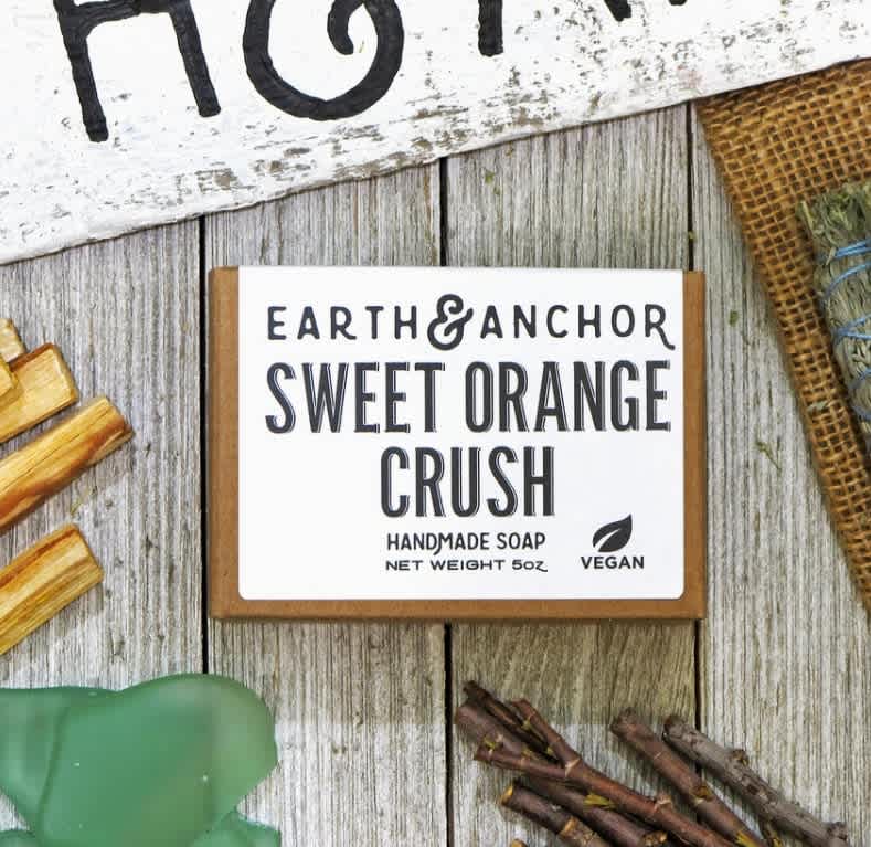 Sweet Orange Crush Handcrafted Vegan Soap - Earth &amp; Anchor Soap Co (DB) - Sweet Orange Crush Soap is a citrus blast of sweet orange, grapefruit, and lemon. With a proprietary blend of Olive, Coconut &amp; Castor oils, we have created the perfect clean. For body, hands, or hair, we have created a blend that is all purpose and bubbly, moisturizing, and leaves you feeling fresh. Our soaps are always vegan, cruelty-free, and all-natural.  Ingredients: Saponified Oils of Olive, Coconut &amp; Castor, and Fragrance.  Earth &amp; Anchor Soap Co. Handcrafted. Cruelty Free. Palm Free. Vegan. E&amp;A soaps are meticulously handcrafted with original formulations &amp; high quality ingredients using the traditional cold-process method. Every soap bar is made, cut, and packaged by hand (specifically...two sets of hands). Soaps are packaged in a plastic-free &amp; recyclable box with ingredient information. E&amp;A Handcrafted Vegan Soap is a great everyday purchase for folks shopping for themselves &amp; family 