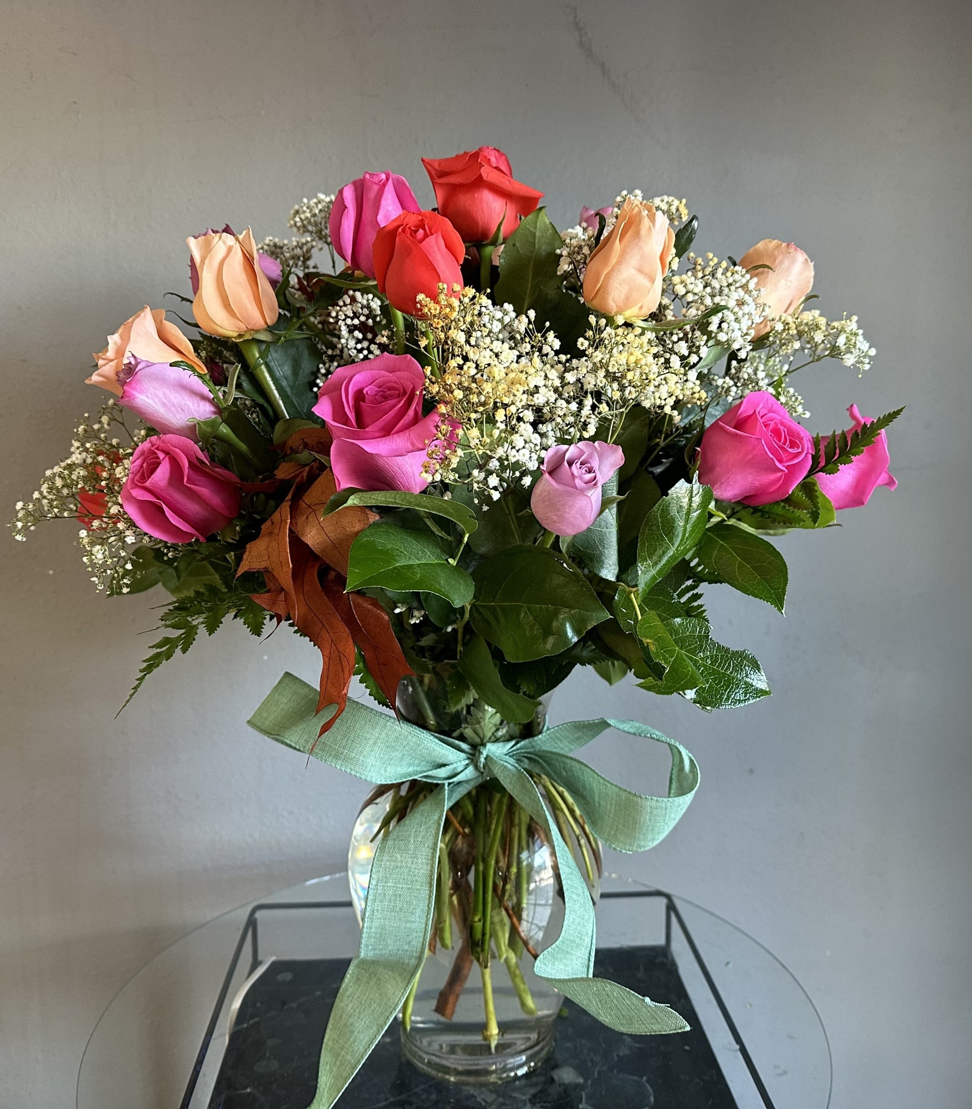2 Dozen Short Stem Mixed Colored Roses 11" vase - An impressive arrangement of 2, 3 or 4 dozen mixed color roses, 40cm rose special, in a 11" vase with greens and filler, red rose not available. This is true eye candy and will say all that it needs to. Truly perfect for any occasion! 