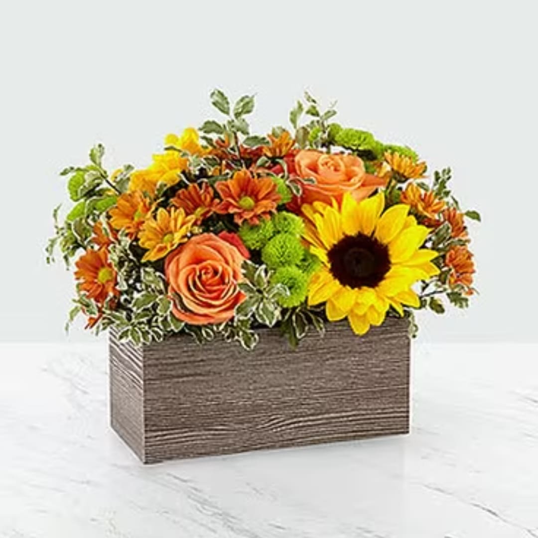 Mixed orange and yellow flowers in a rectangular wood box