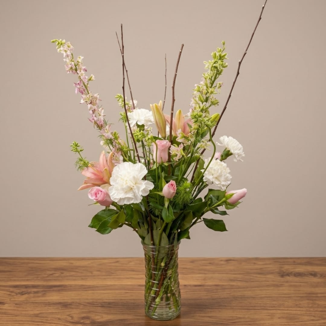 Pink and white floral arrangement in a clear glass vase