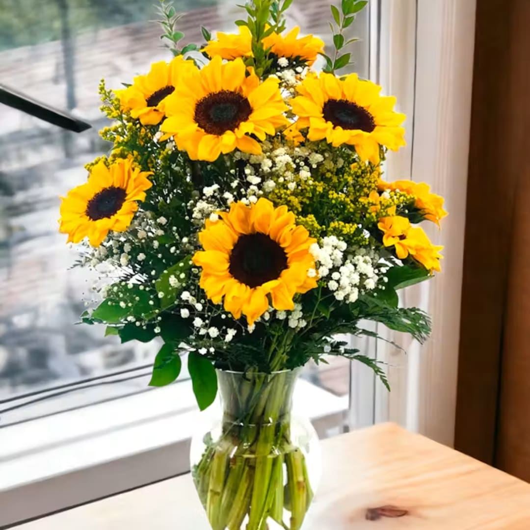 Sunflower bouquet in a clear glass vase on a table