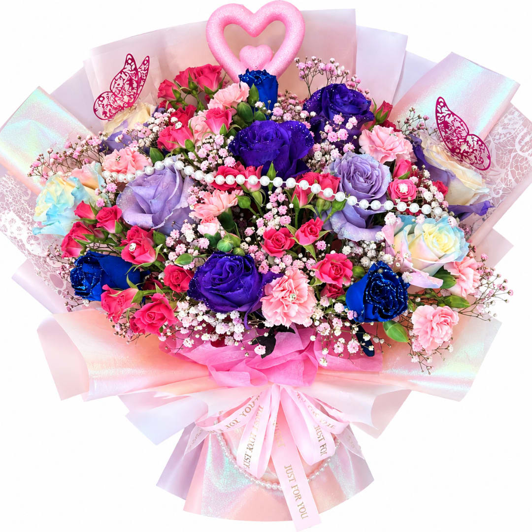 Large bouquet of pink, purple, and blue roses with a heart topper