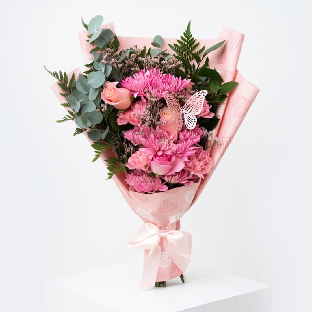 Pink bouquet with roses and chrysanthemums wrapped in pink paper
