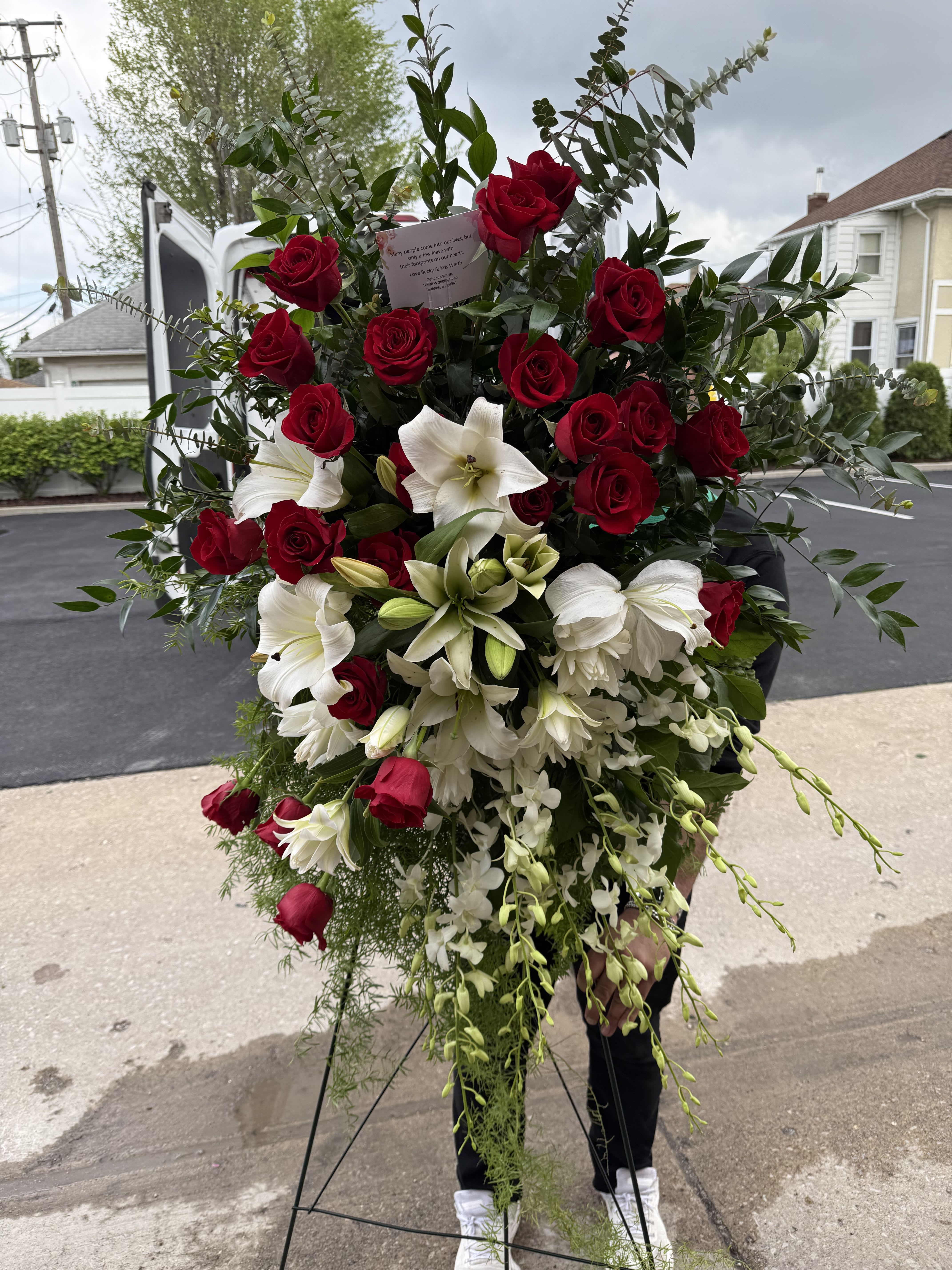 Large standing floral spray with red roses and white lilies