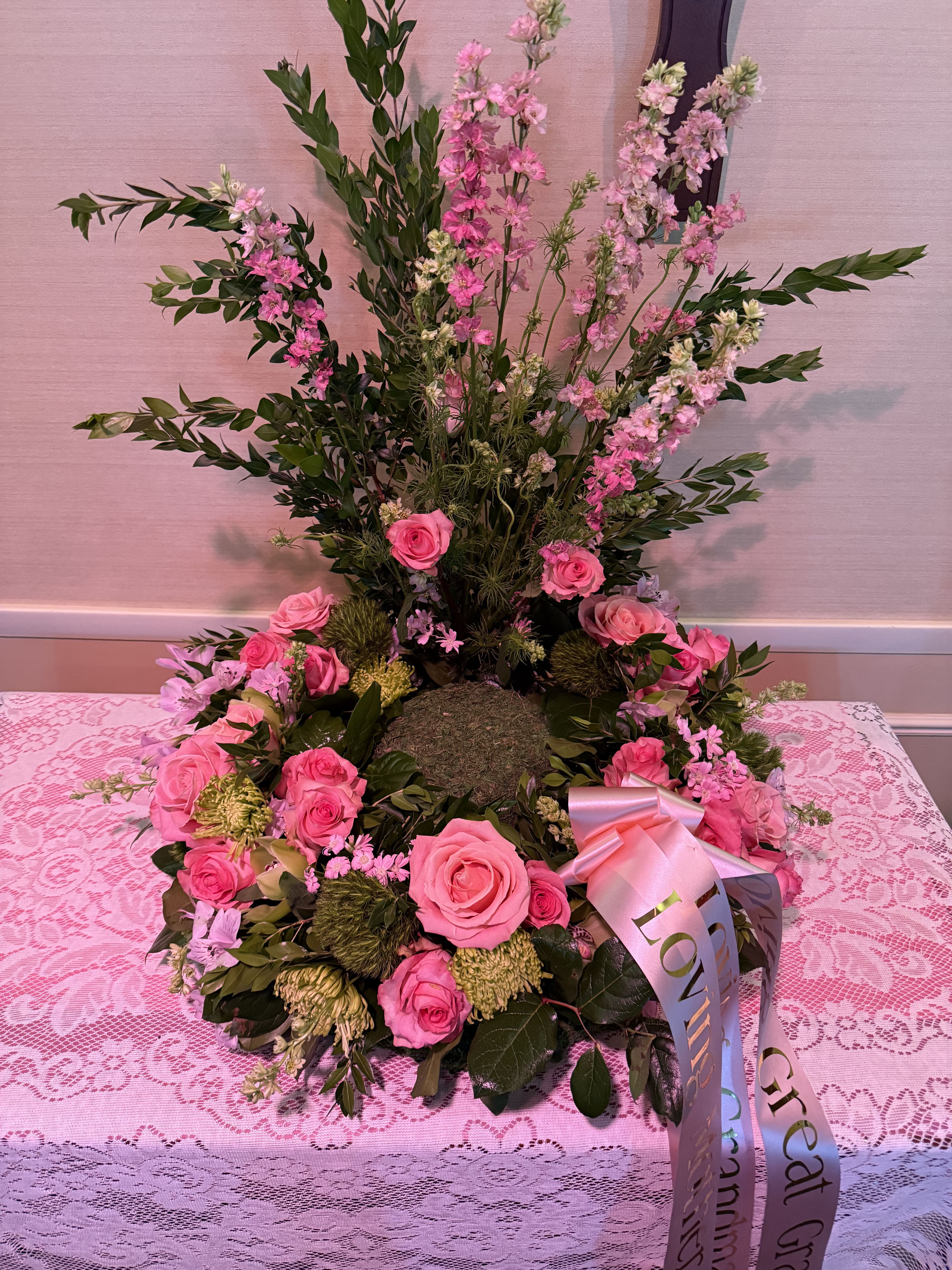 Pink rose wreath with tall pink blossoms and a satin ribbon bow