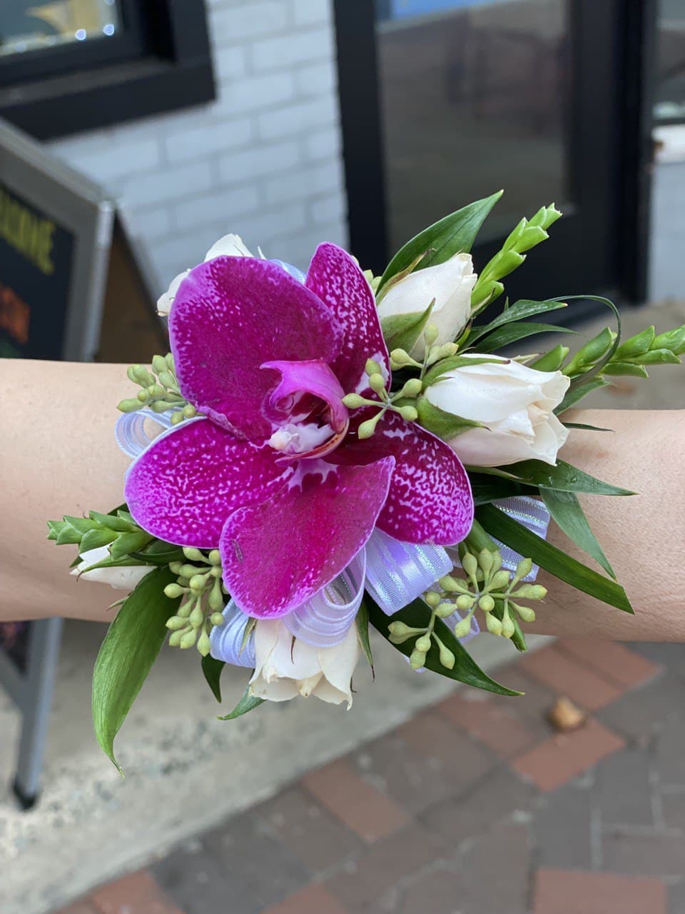 Wrist corsage with purple orchid and white roses
