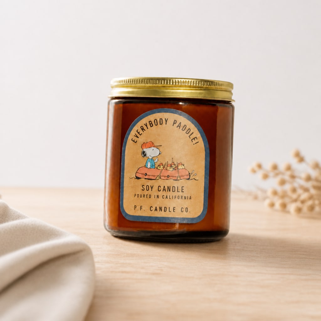Soy candle in a glass jar with a gold lid and illustrated label