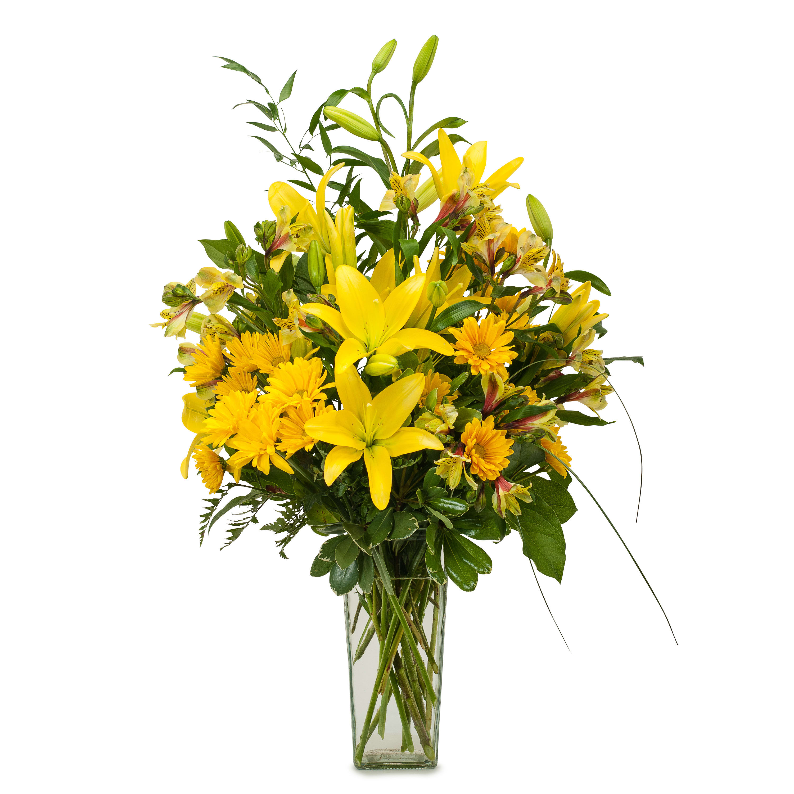 Yellow lilies and daisies arranged in a clear glass vase