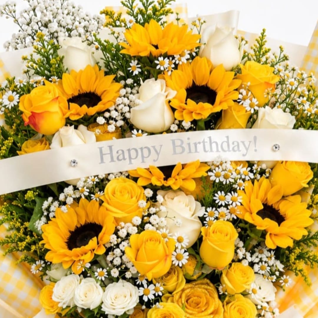 Yellow and white bouquet with sunflowers, roses, and daisies, wrapped with a birthday ribbon
