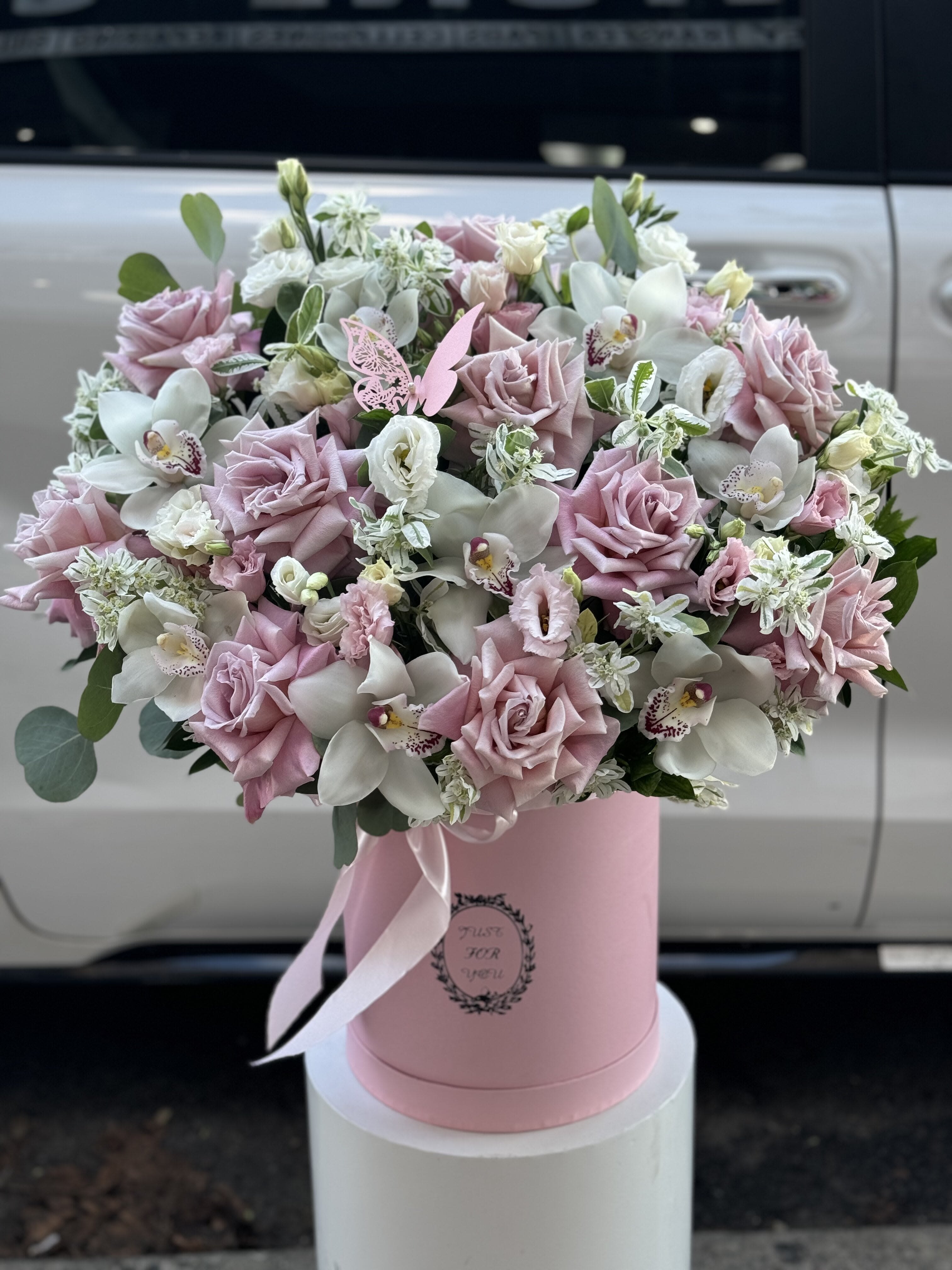 Pink and white bouquet in a pink hatbox with ribbon