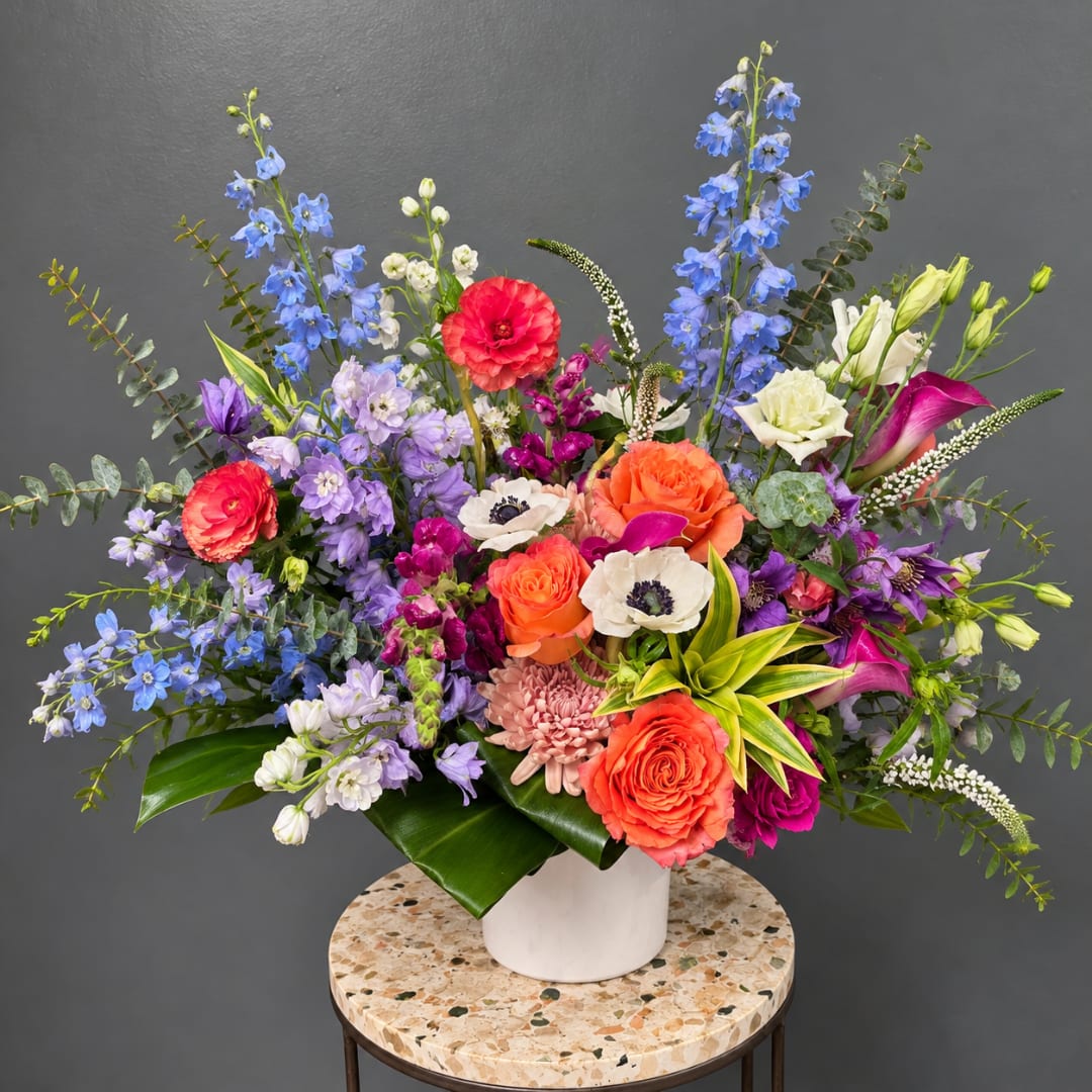 Colorful mixed flower arrangement in a white vase