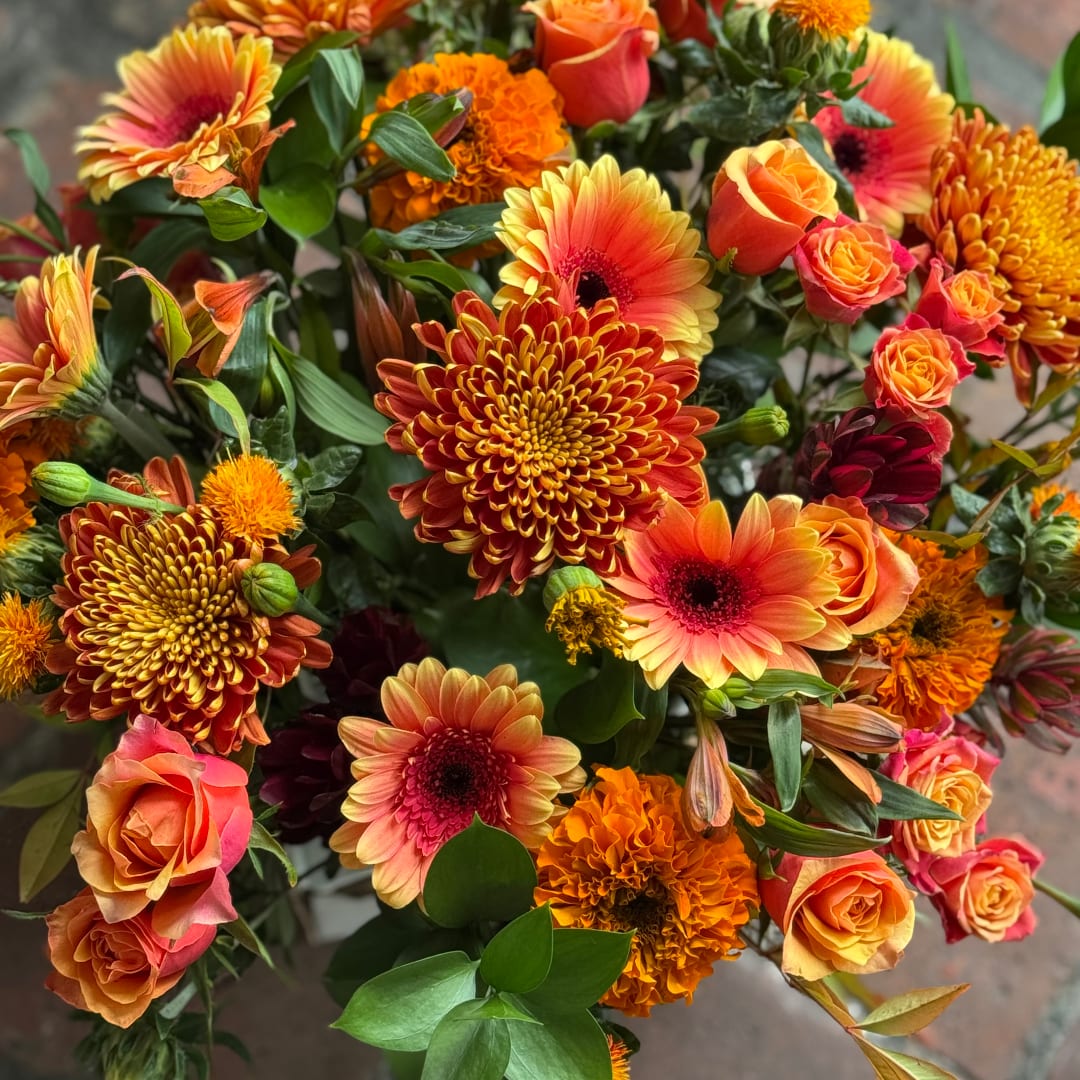 Orange and pink mixed bouquet with roses, gerbera daisies, and chrysanthemums