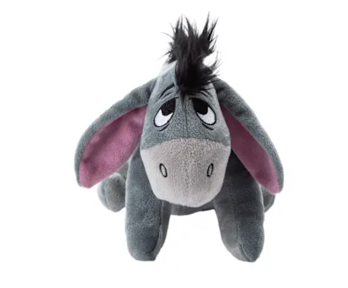 Gray plush donkey with pink ears and a black mane on a white background