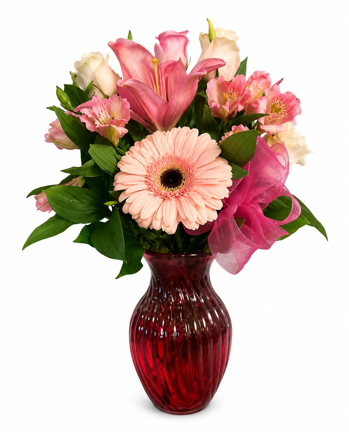 Pink and cream mixed bouquet in a red glass vase